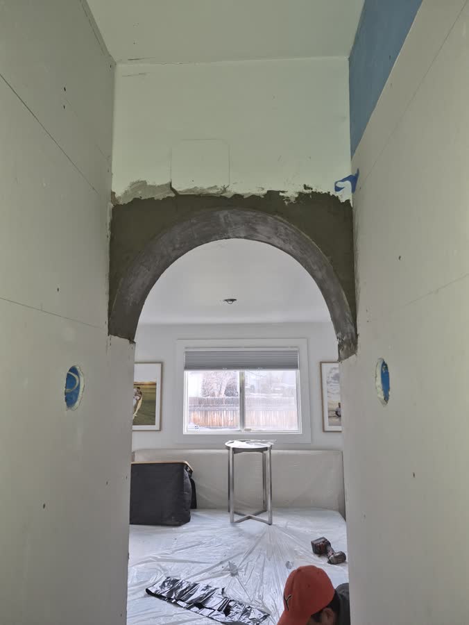 An arched interior opening framed and plastered by the crew