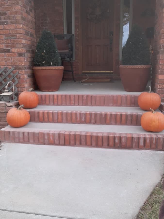 Brick front steps onto a smooth concrete walk