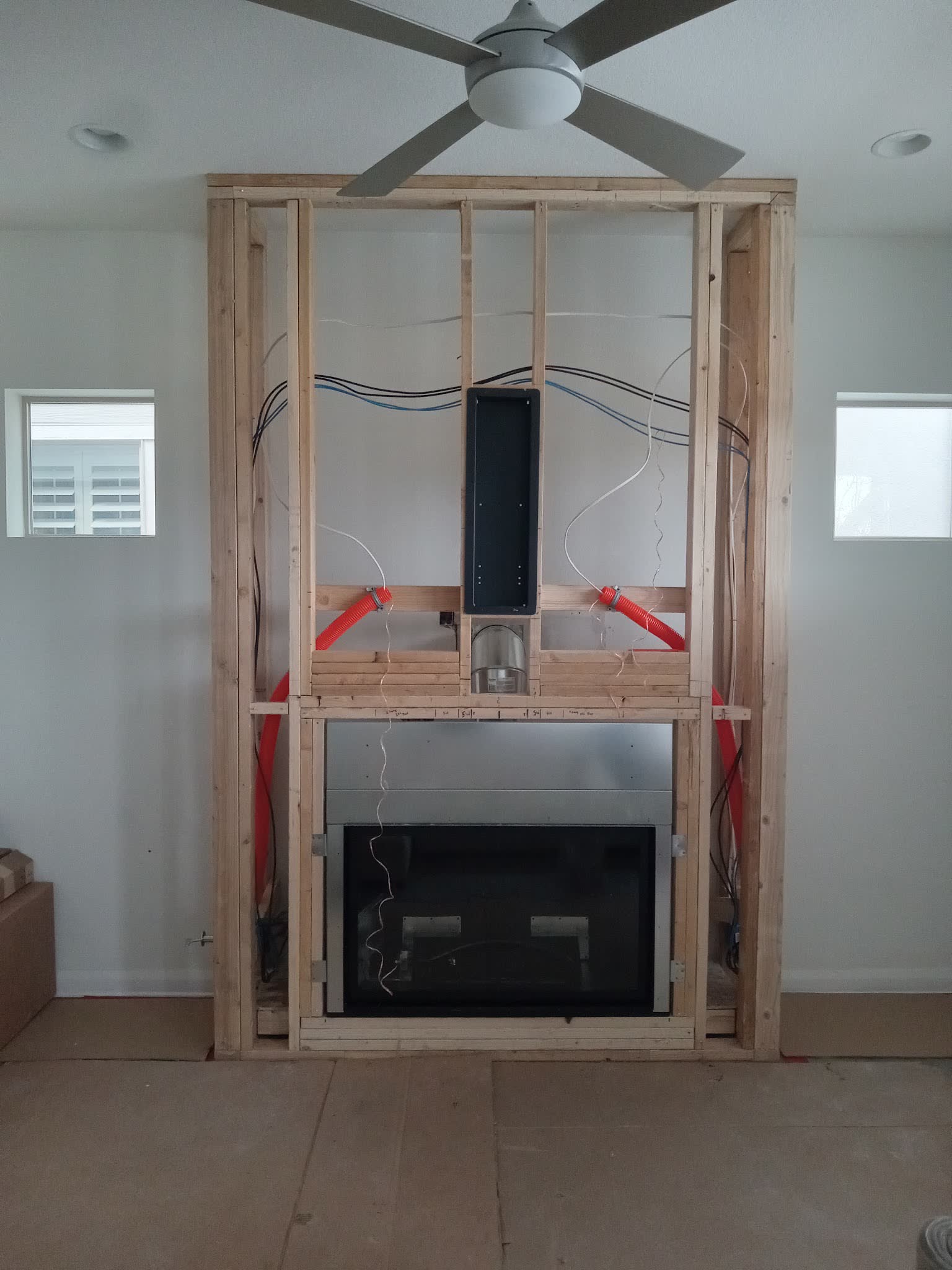 Stud framing, wiring and a steel firebox before the stone goes on